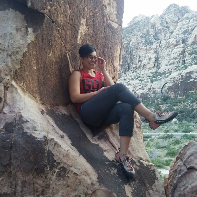 person sitting on a boulder